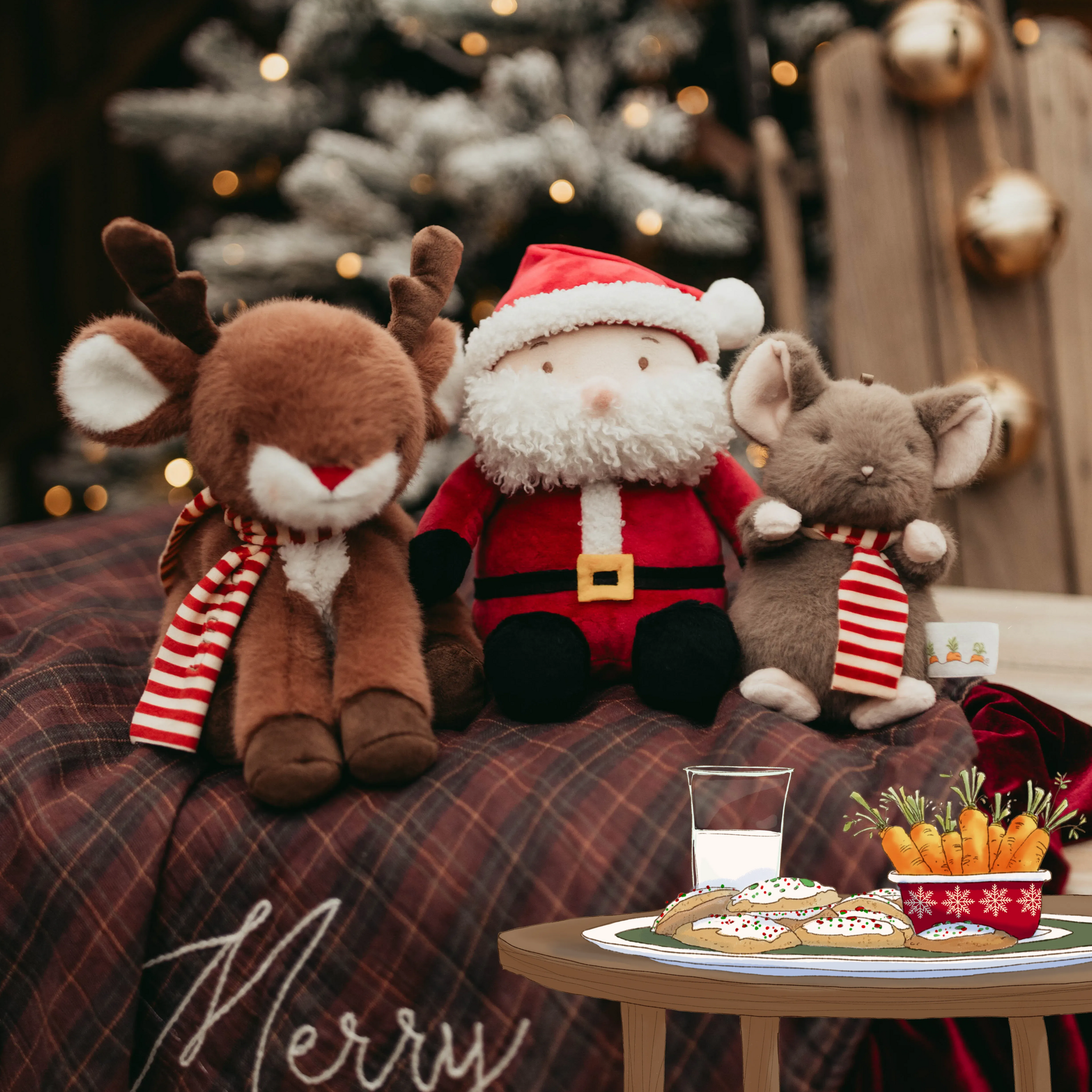 Christmas-themed scene with stuffed reindeer, Santa, and mouse on a plaid surface, with a small table of cookies and milk.