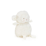 White stuffed lamb toy on a white background