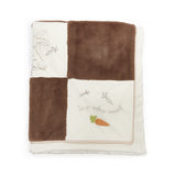 Patchwork blanket with embroidered designs on a white background