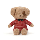 Stuffed dog toy wearing a red sweater with white patterns on a white background