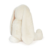 Back view of a cream colored plush bunny.
