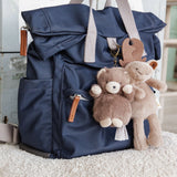 Bear and moose bag charms, attached to a blue and gray backpack.