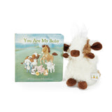 Plush baby cow animal toy and children's book titled 'You Are My Baby' on a white background