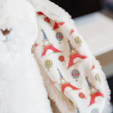 Close up of Paris inspired print on the inner ear of a cream colored plush bunny