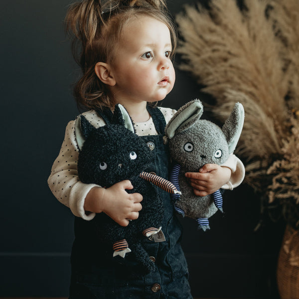 Little Girl holding Boo Boo Kitty and Eek the Bat