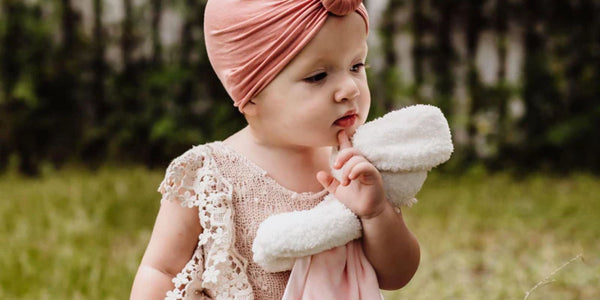 Toddler holding a Blossom Buddy Blanket