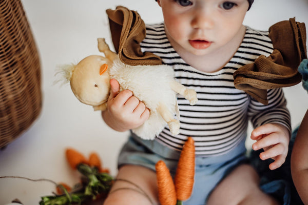 baby holding a chick roly poly