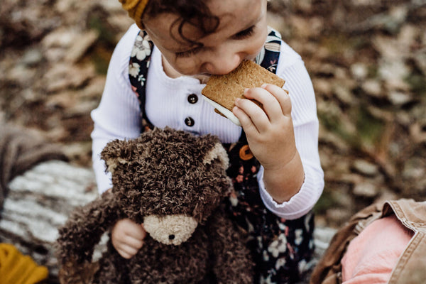 Little Girl holding our Cubby The Bear Stuffed animal