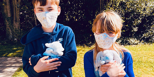 Kids holding bunnies w/face masks on them