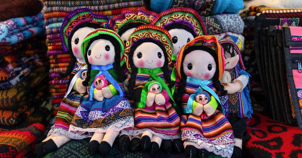 Traditional dolls from Peru are being sold as souvenirs. They are handcrafted and sewn with colorful fabrics and designs.