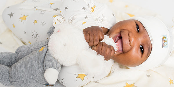 Baby playing with a lovey