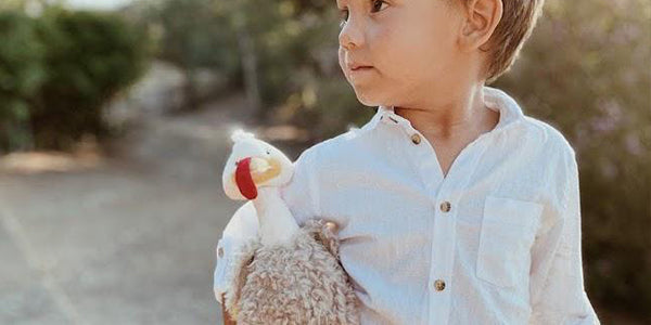 Little boy holding Gracious Gobbler Turkey