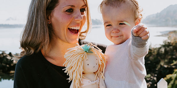 Mom holding a toddler girl
