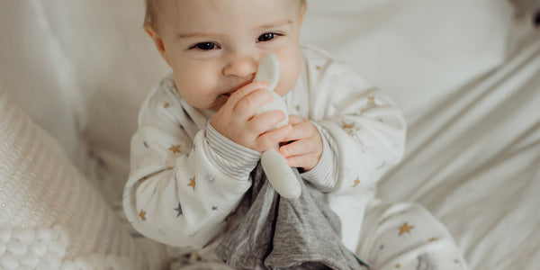 Baby playing with a lovey