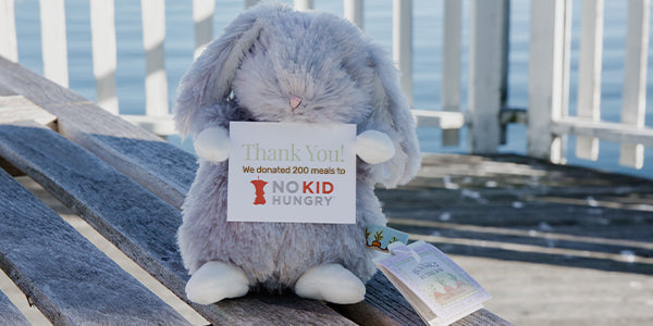 Wee Bloom holding a No Kid Goes Hungry sign