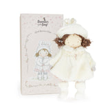 Stuffed doll in a white outfit with a matching box on a white background