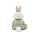 Plush toy rabbit in a green outfit with a white hat on a white background