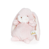 Pink plush bunny toy with a white tag on a white background