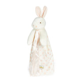 side view Plush bunny toy with a white and pink polka dot blanket on a white background