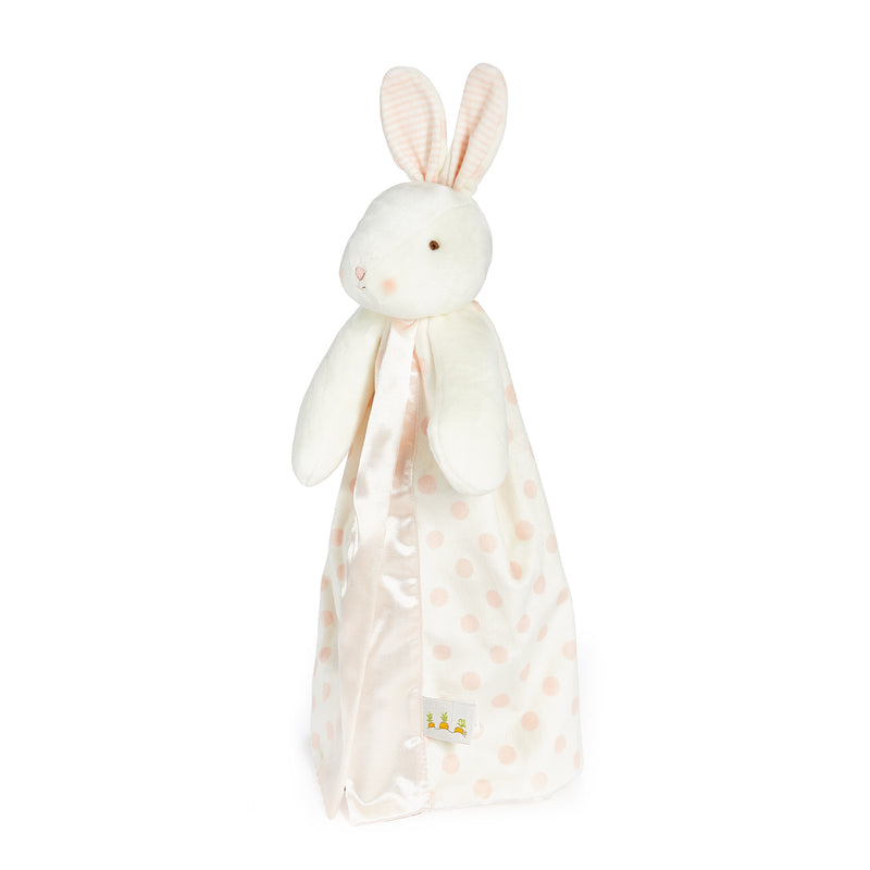 side view Plush bunny toy with a white and pink polka dot blanket on a white background