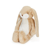 Plush bunny toy with beige and white fur on a white background