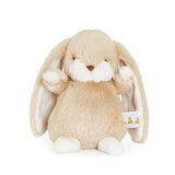 Plush bunny toy with a white tag on a white background
