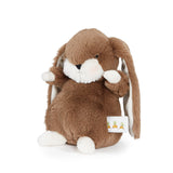Brown plush bunny with a white tag on a white background