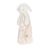 White plush bunny with a pink blanket on a white background
