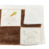 A soft brown and cream quilt, folded to show the fuzzy backing.