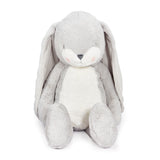 Plush toy rabbit with gray fur and white belly on a white background