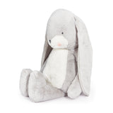 Gray plush bunny toy with a white belly on a white background