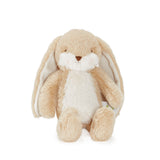 Plush bunny toy with beige fur and white accents on a white background