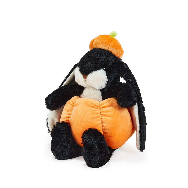 Plush bunny toy with a pumpkin costume on a white background