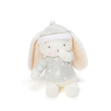 Plush toy rabbit in a polka dot outfit on a white background