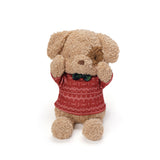 Stuffed dog toy wearing a red sweater with white patterns on a white background