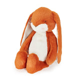 Orange stuffed animal bunny with long ears on white background