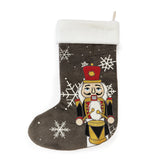 front view dark gray Christmas stocking with nutcracker design and snowflakes on a white background