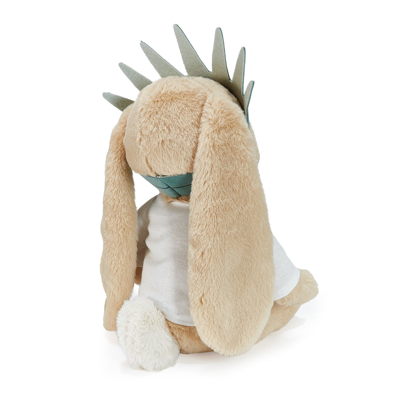 Plush toy resembling a character with long ears and a white outfit on a white background