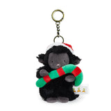 Plush lamb keychain with a red and green candycane on a white background