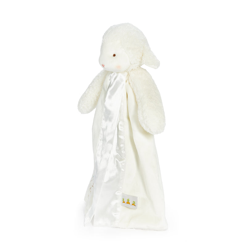 side view White plush toy with a blanket on a white background