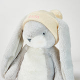 Plush toy with a beige hat on a light gray background