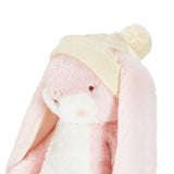 Pink plush toy with a cream knit hat on a white background