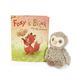 Children's book titled 'Foxy & Blink Flying Lessons' with a plush owl toy on a white background