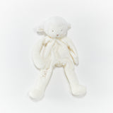 White plush lamb with a bow on a white background