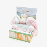Box of plush bunny toys with a gift box on a white background