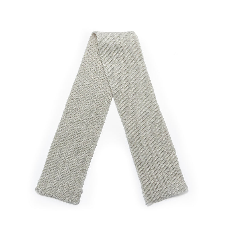 flat lay of Gray knitted scarf on a white background
