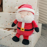 Plush Santa Claus toy on a decorative surface with gift boxes in the background