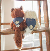 Two stuffed animals, Foxy the Fox and a Harey the Bunny Rabbit, sitting on a wooden ladder with 'Camp Cricket' bandanas. 