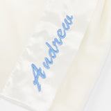 Zoomed image of Embroidered name 'Andrew', custom embroidery on a white fabric background