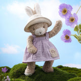 Taupe and white bunny in purple dress with floral accents. 